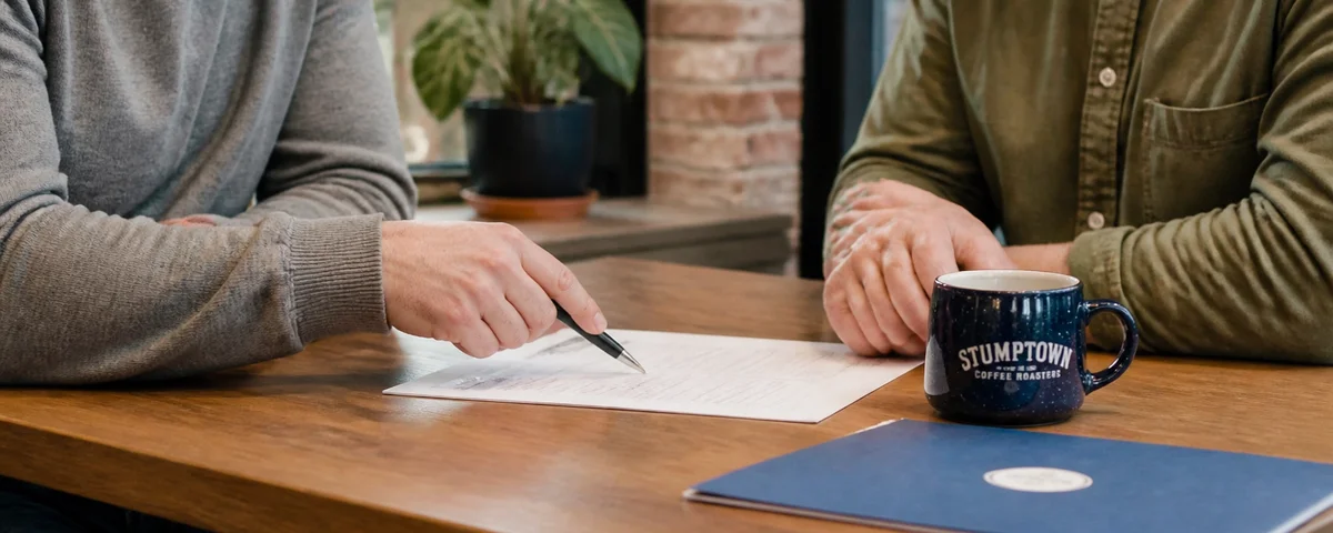 Two buyers reviewing a buyer representation agreement, Portland, Oregon
