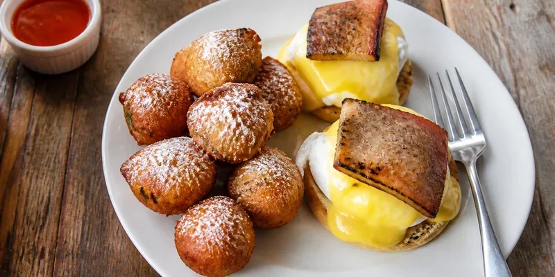 Hush puppies and eggs benedict with smoked pork belly downtown Portland Oregon