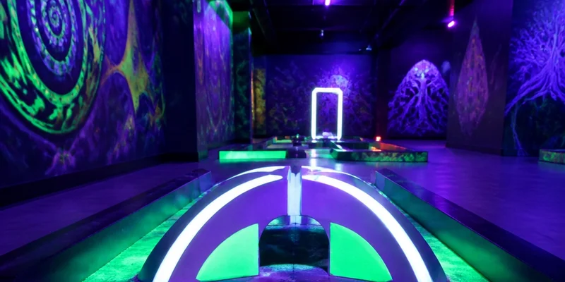 Blacklight miniature golf course with neon obstacles downtown Portland Oregon