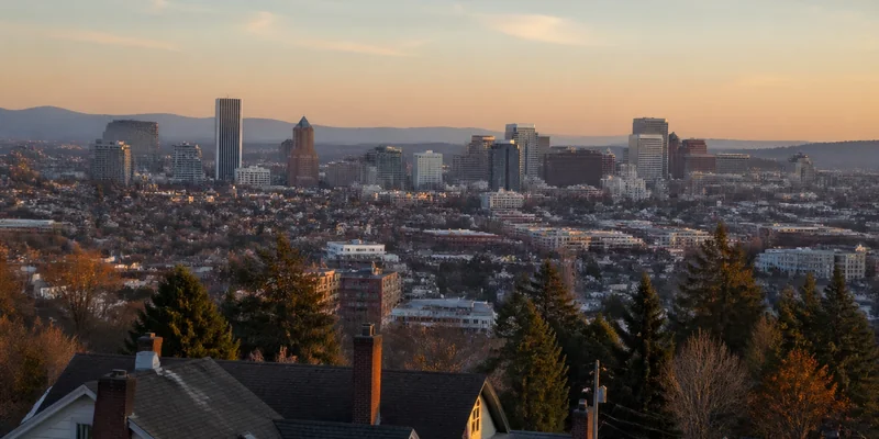 Portland Oregon skyline view from residential hillside neighborhood at golden hour