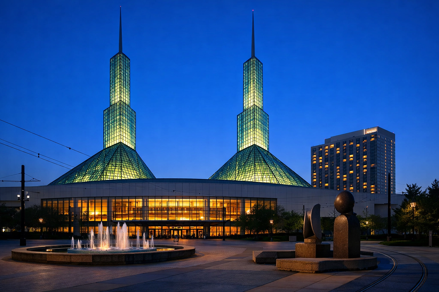 Exterior of the Oregon Convention Center in Northeast Portland's Lloyd District, showing its distinctive twin glass spires against the Portland skyline.